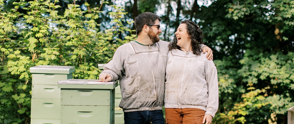 Amy-Beth and her husband, Peter, with their hives - Photo by Holly Cuaresma