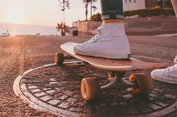 A foot resting on a skateboard