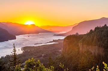 Sunrise over mountainous river valley
