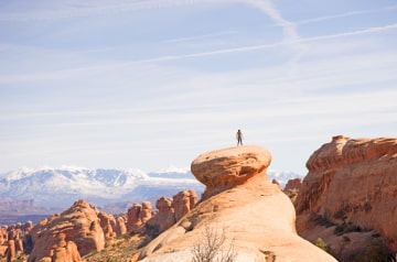 viewing desert landscape from atop tall rock formation