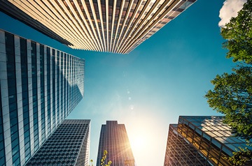 Looking upward along glass-sided building