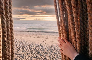 pushing curtain aside to reveal ocean view
