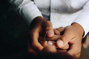 closeup of two people's interlocked hands