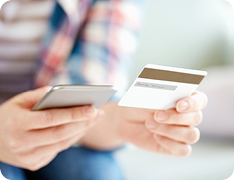 person typing credit card number into phone