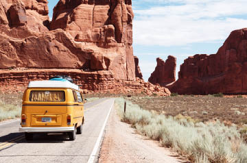 yellow VW bus on desert highway