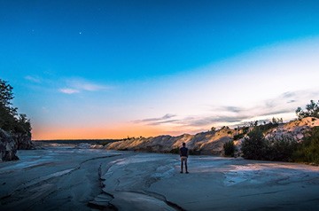 standing on dry beach at sunset