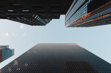 looking upward between skyscrapers