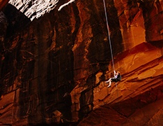 Person rappelling into a cave
