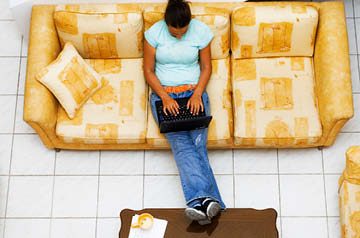 person using laptop on couch