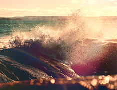 crashing ocean waves at sunset