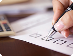 closeup of hand writing in checkbox