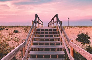 Looking up wooden steps going across sand dunes