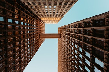 Looking skyward in the middle of three skyscrapers