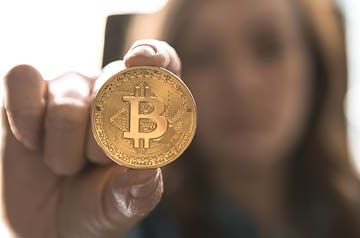 person holding Bitcoin