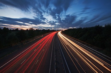 Blurred car lights on highway at dawn