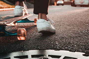 closeup of skateboarder riding on road