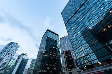Looking skyward along glass-sided skyscrapers