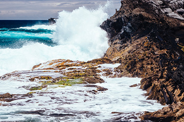 waves crashing against coastal rocks