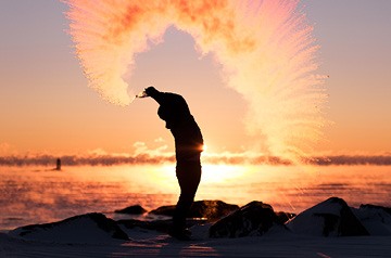 tossing sand in air on beach