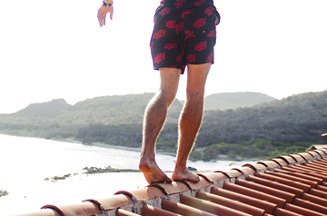 person walking on rooftop in coastal city