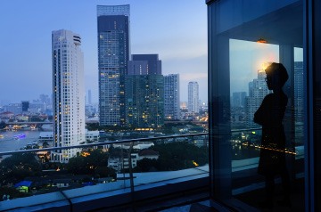 Business person looking out over downtown cityscape