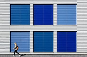 walking in front of blue paneled wall