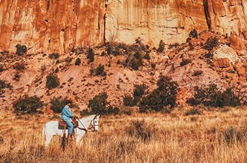 riding horse through desert