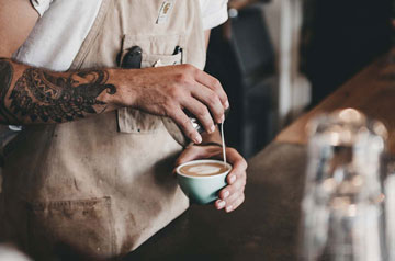 barista pouring latte art