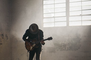 playing guitar in warehouse