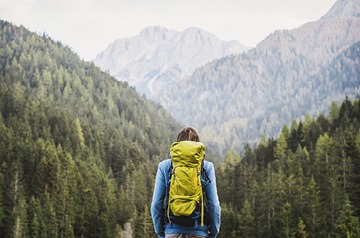 Hiker looking towards mountain range