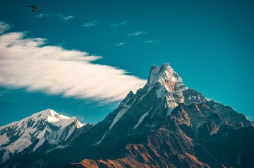 Snowy mountain peak against clear blue sky