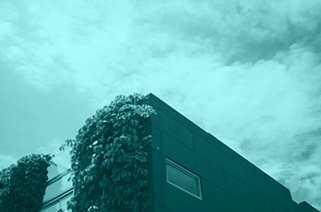 Multi-story building with foliage on one side