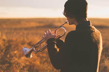 playing horn in field