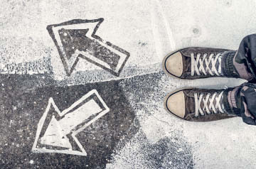 person standing before two arrows