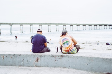 sitting on beach boardwalk