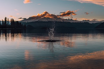 skipping rocks on mountain lake