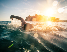 person swimming in open water