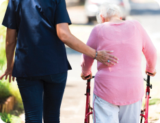 nurse walking with elderly patient