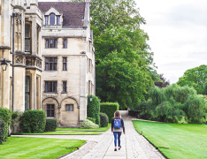 person with backpack walking through university campus
