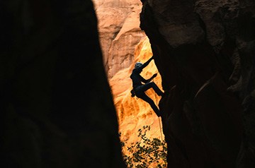 Rock climber ascending a canyon