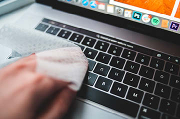 A person cleaning a keyboard