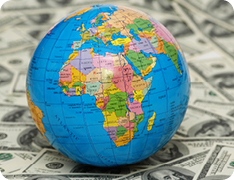 globe resting on stack of money