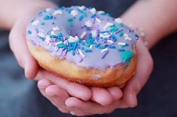 hands holding a donut