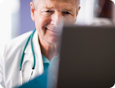 smiling doctor looking at screen