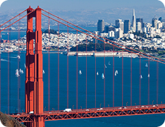 Golden Gate Bridge in foreground, San Francisco skyline in background