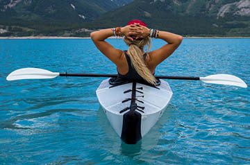 person enjoying landscape from kayak
