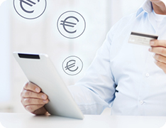 man holding an iPad and a credit card