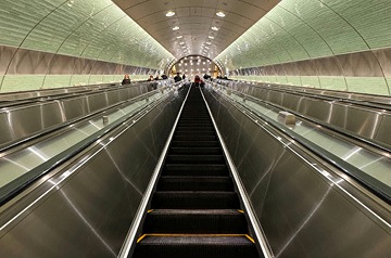 Looking down a lighted subway tunnel
