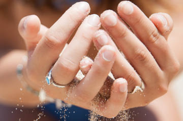 Sand falling through two hands