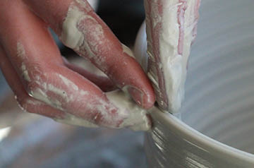 potter spinning clay